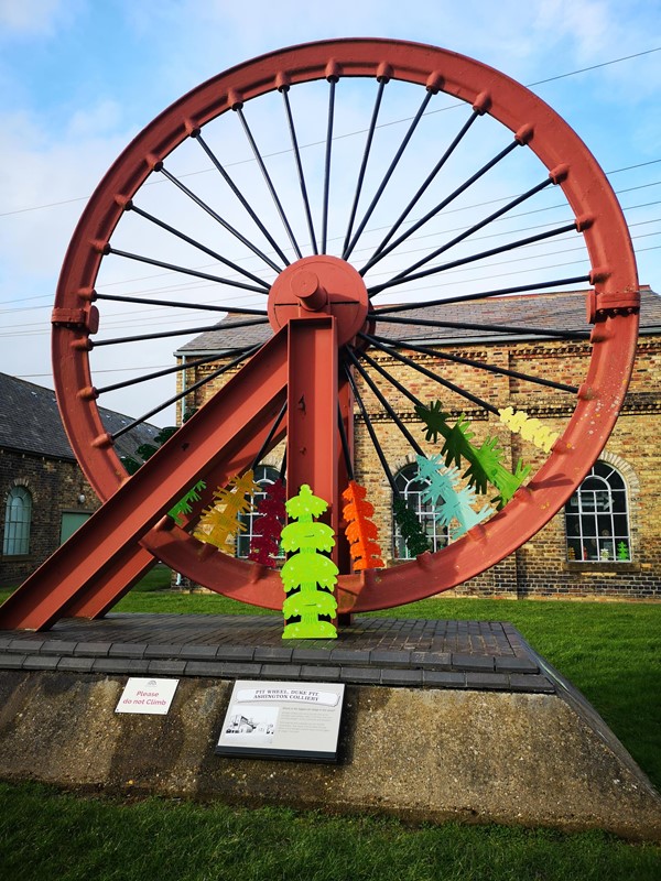 Showing the pit wheel from Duke Pit which has been mounted as a display near the entrance/exit