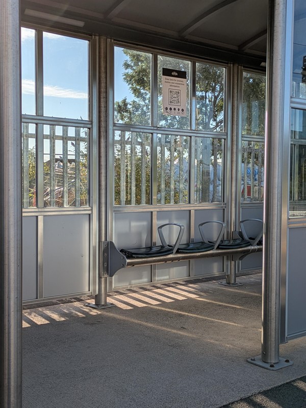 Image of rain shelter and bench seating with armrests