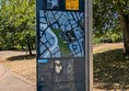 Image of signage fo Castle Park showing current location and routes through the park