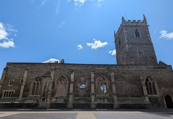 Image of the ruins of  St. Peter's Church set against a blue sky with sparse clouds