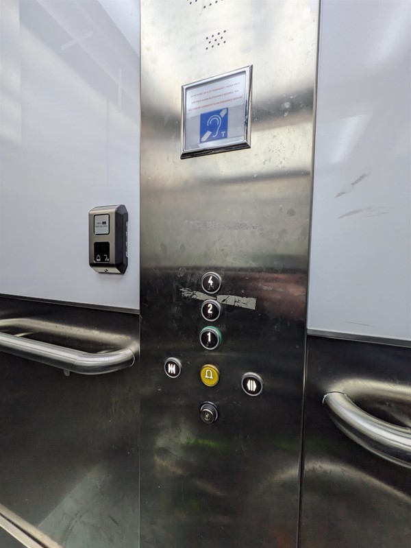Image of lift buttons. The lift buttons have braille markings.