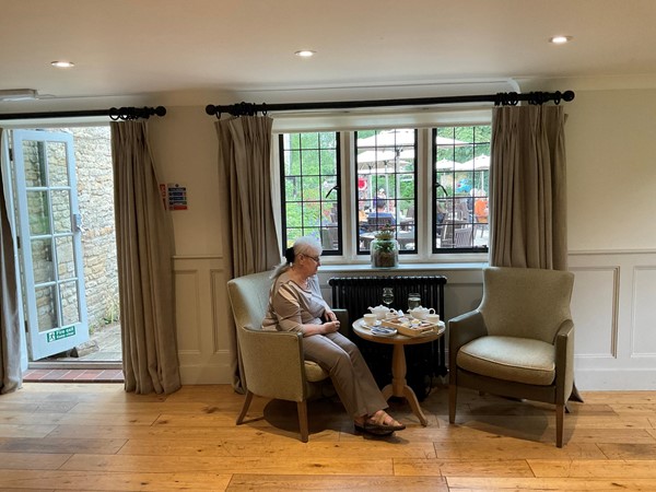 Person sitting at a table by a window