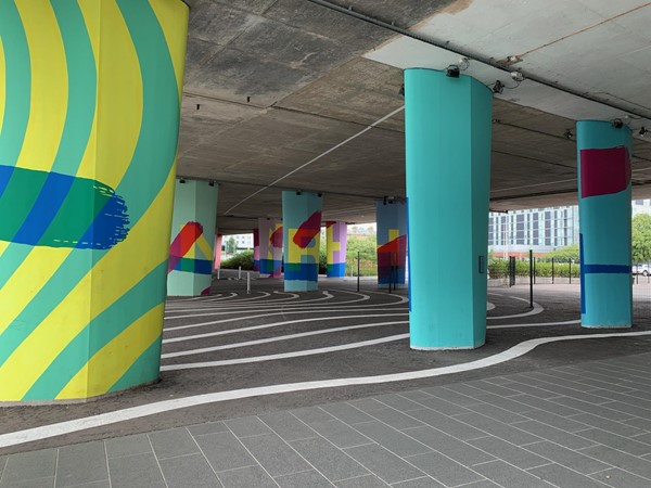 The colourful artworks under the bridge; created by painting the bridge's supporting pillars
