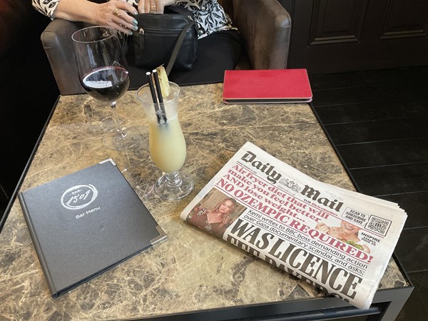 Image of a paper and a menu on a table.