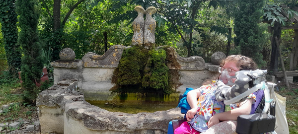 Image of a person by a well