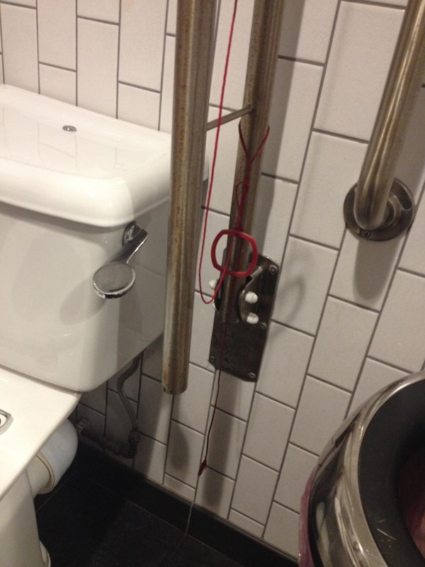 Red emergency cord had been tied to the handrail in a complex knot