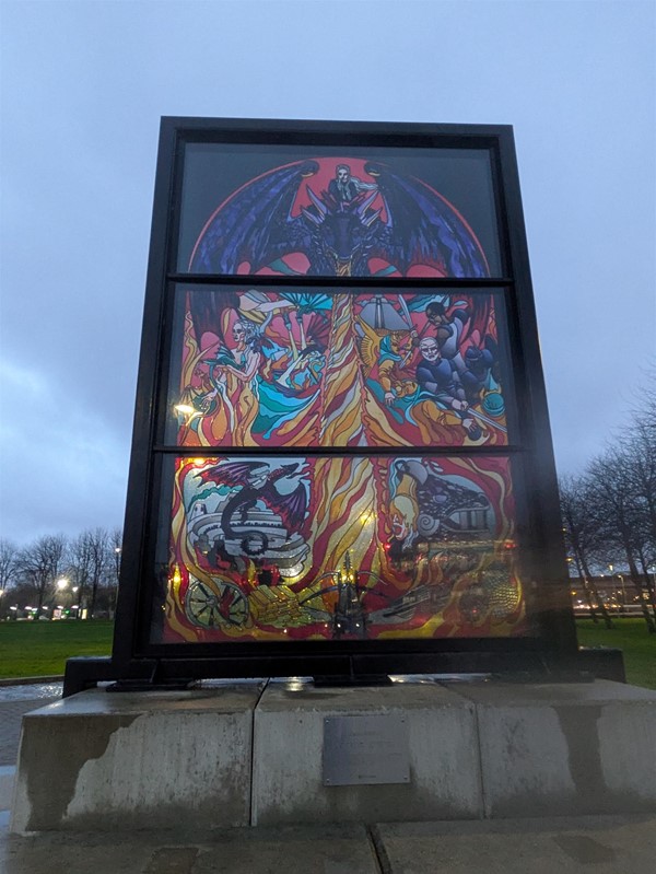 Image of a glass window by the Riverside showing Daenerys Targaryen atop a fire-breathing dragon.