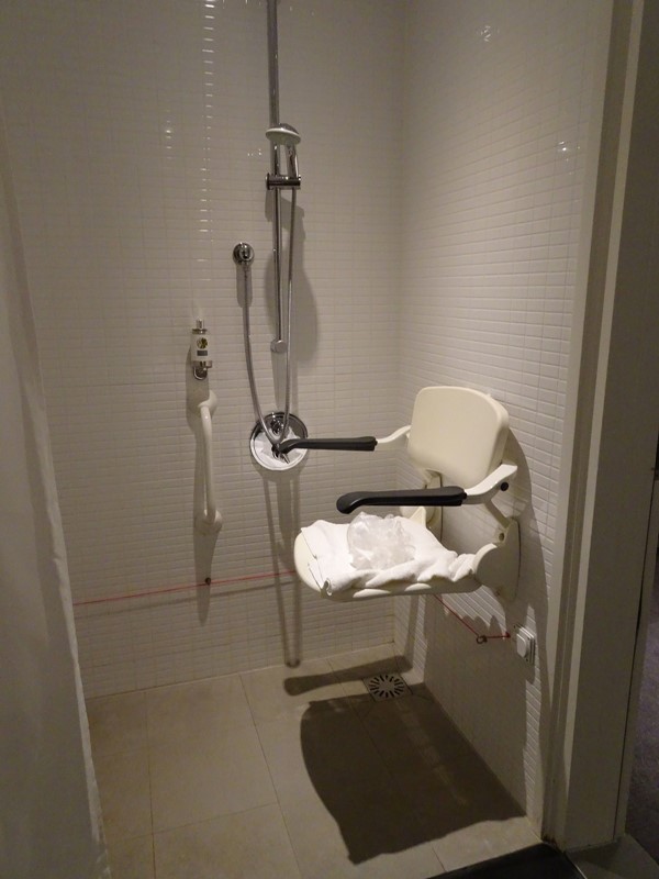 Roll-in wet room shower. Note the red horizontal alarm cord which extends all the round the bathroom apart from the doorway.