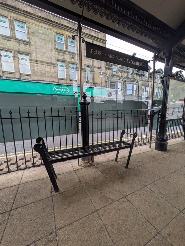 Image of a metal bench with no back on it