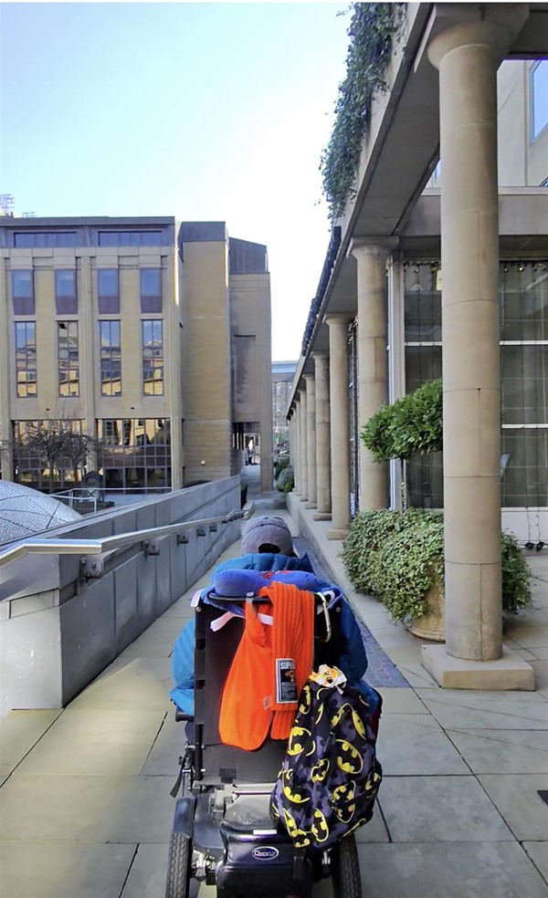 Image of a powerchair going along a path
