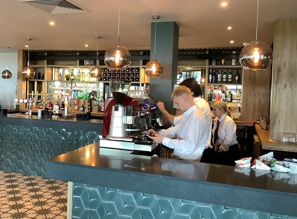 Picture of a coffee machine being operated