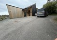 Image of a wooden building and a car
