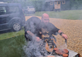 Image of a person operating a barbeque