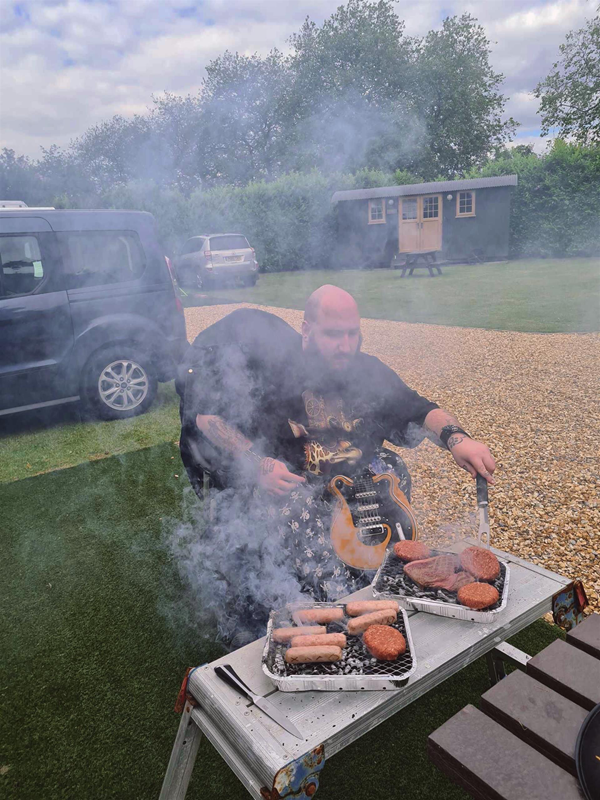 Image of a person operating a barbeque
