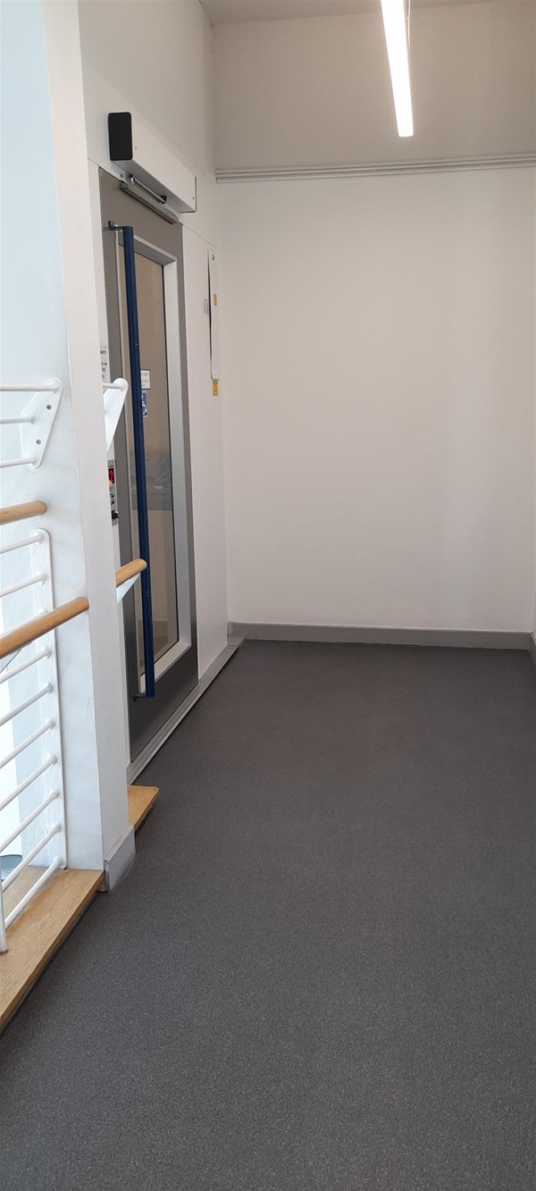 Image of a double door at the end of a corridor