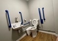 Image of a toilet with grabrails