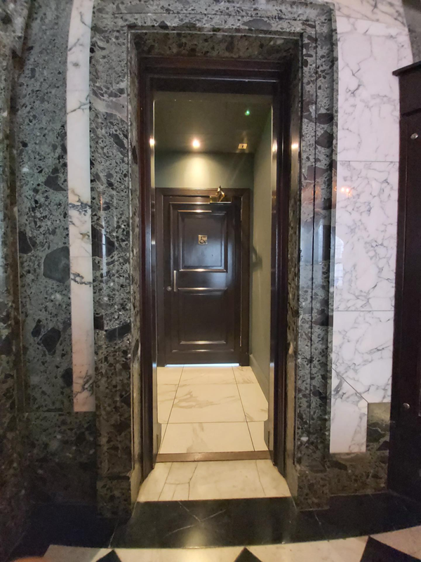 The narrow doorway before the accessible toilet.