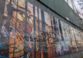 Image of mural showing soldiers, covered in graffiti