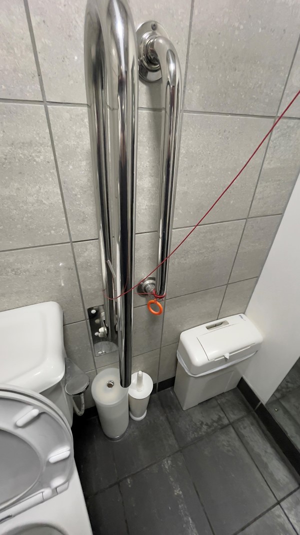 Emergency pull cord inaccessible to anyone on floor.