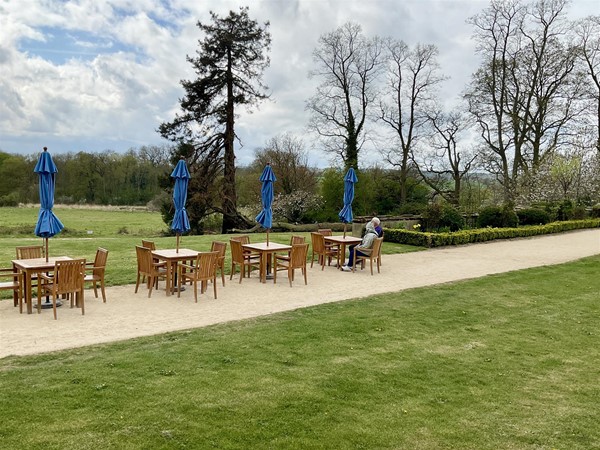Image of tables. chairs and umbrellas outside