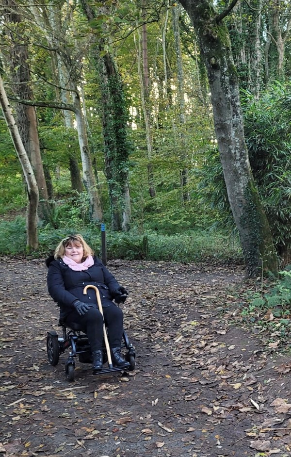 Picture of a powerchair user in a wood