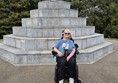 Image of a wheelchair user in front of a memorial
