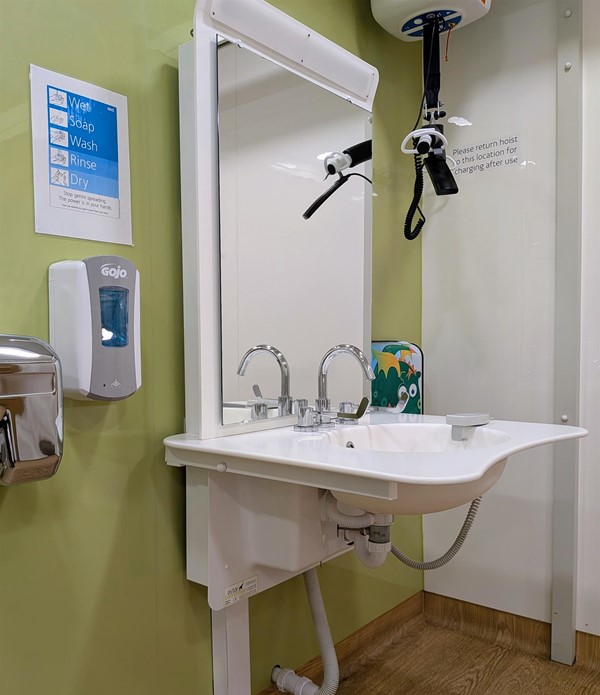 Image of height-adjustable sink and ceiling hoist