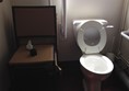 Picture of the Barley Mow - London  - An accessible toilet is NOT a store-room for spare furniture. This stack of 4 chairs next to the toilet made sideways wheelchair-to-toilet transfer impossible.