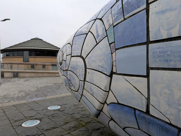 Image of The Big Fish showing images and text on the blue and white scales
