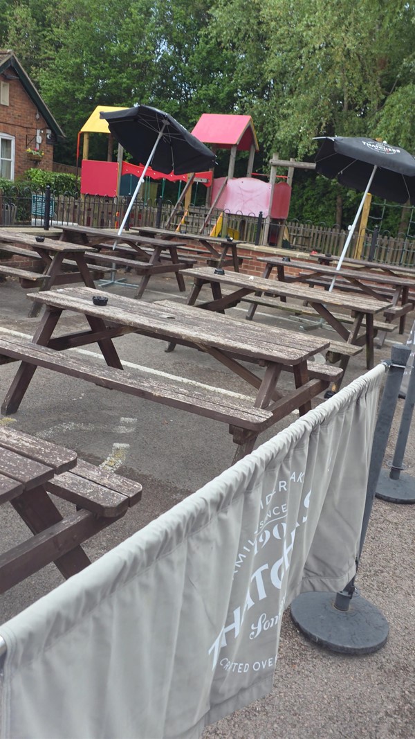 Third accessible parking space with benches blocking use.