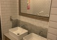 Image of a mirror and two sinks