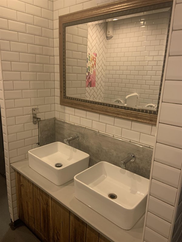 Image of a mirror and two sinks