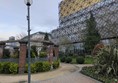 Image of a walkway in the park with the library in the background