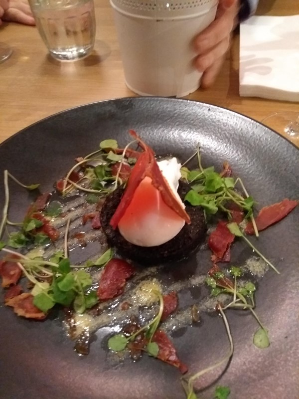 Black pudding, poached egg, panchetta and salad.