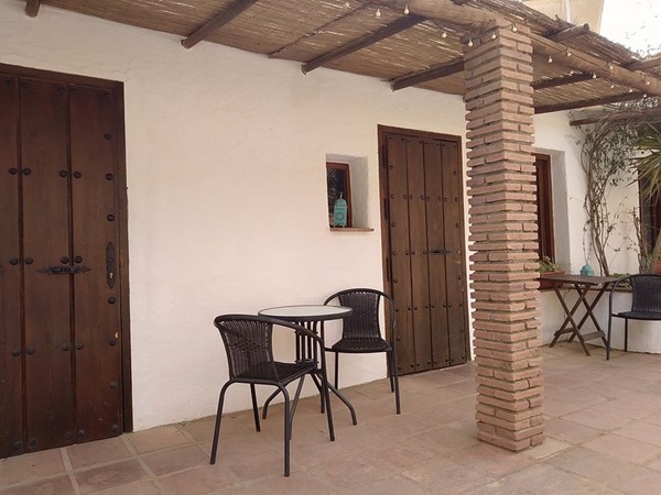Image of a patio area with a table and 2 chairs.