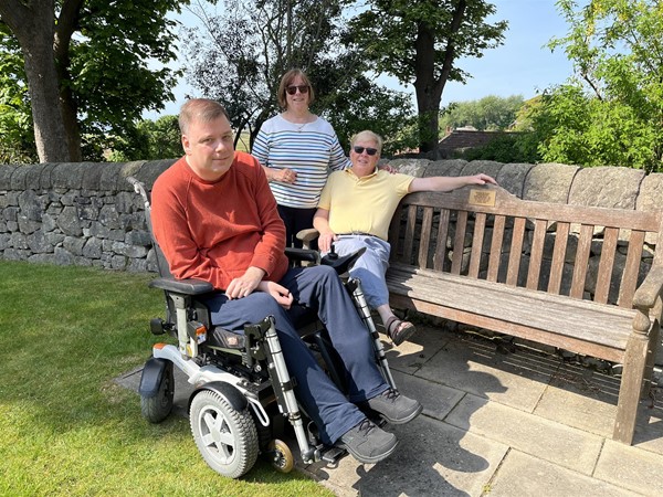 Image of three people in a grden