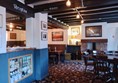 The inside of the pub/bar area, carpeted and with plenty of space.