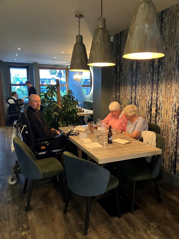 Image of our reviewer sitting at his table in the restaurant.