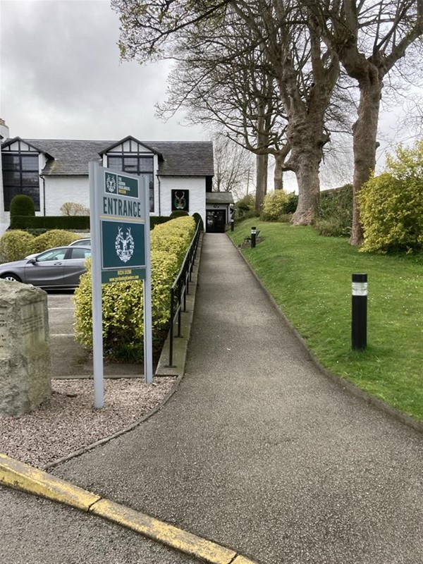 Image of an entrance sign and path