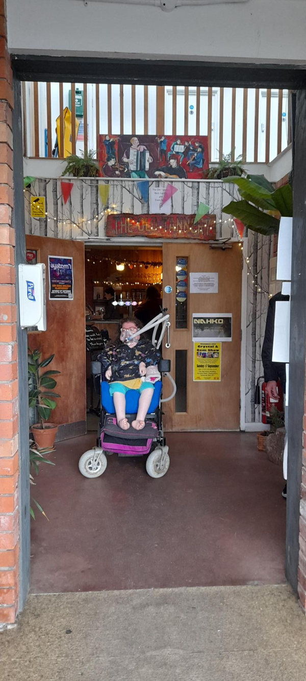 Powerchair user in doorway