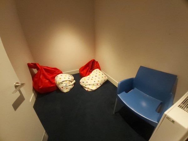 Quiet room with bean bags, cushions a chair and a radiator