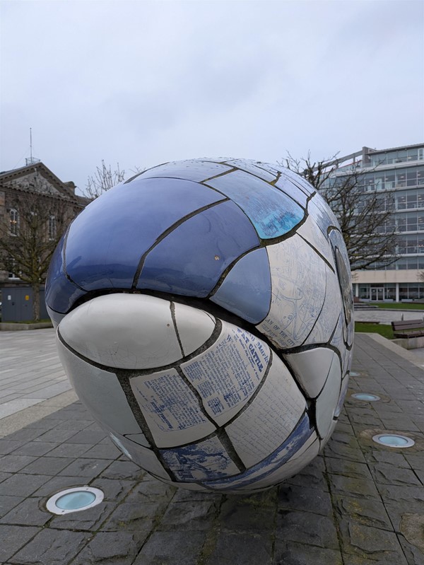 Image of The Big Fish showing images and text on the blue and white scales - close up of the statue's mouth