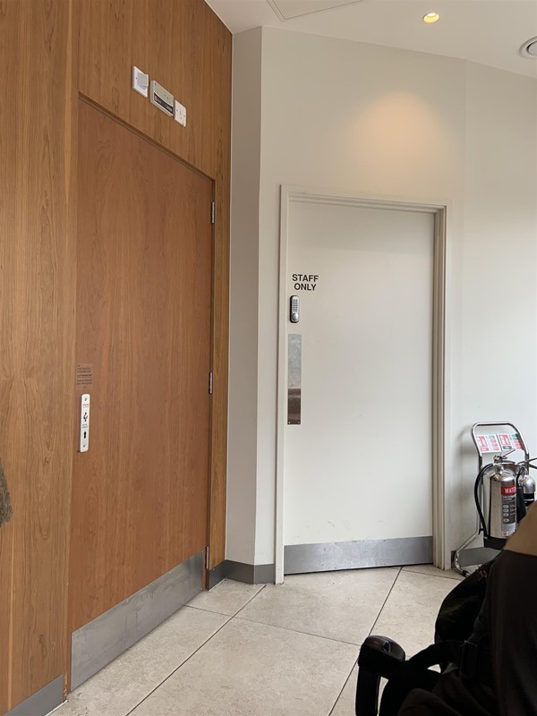 Image of two doors at the back of the shop. The wide wooden door on the left has a RADAR lock. The smaller white door on the right has a code lock and says “STAFF ONLY”.