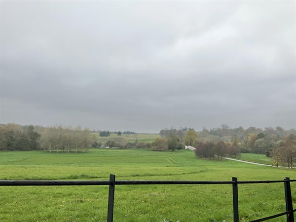 Image of a field through a fence