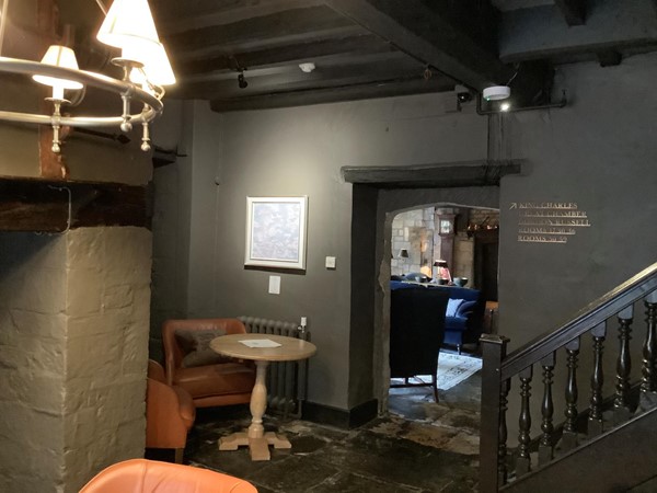 Picture of a table in a corner in a room with some stairs