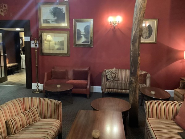 Picture of a warm looking pink red room with nice places to sit