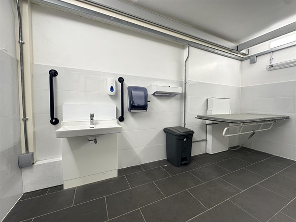 Image of large accessible Changing Places toilet with height-adjustable bench