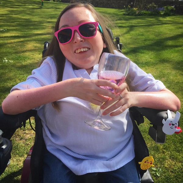 Image of Claire enjoying the sunshine with a glass of gin.