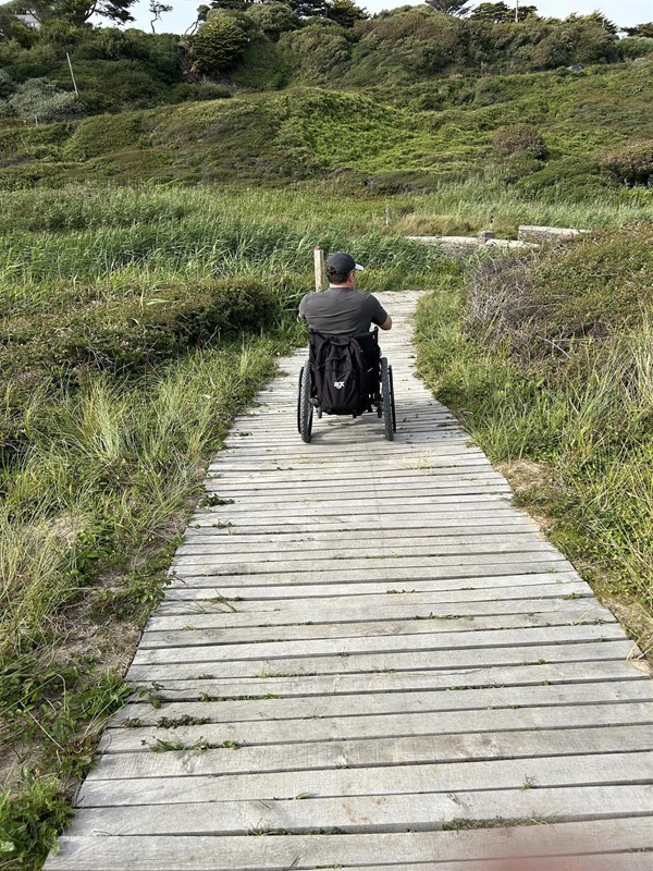 Image of a wheelchair user on a boardwalk