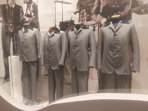 Image of a group of men's suits in a display case